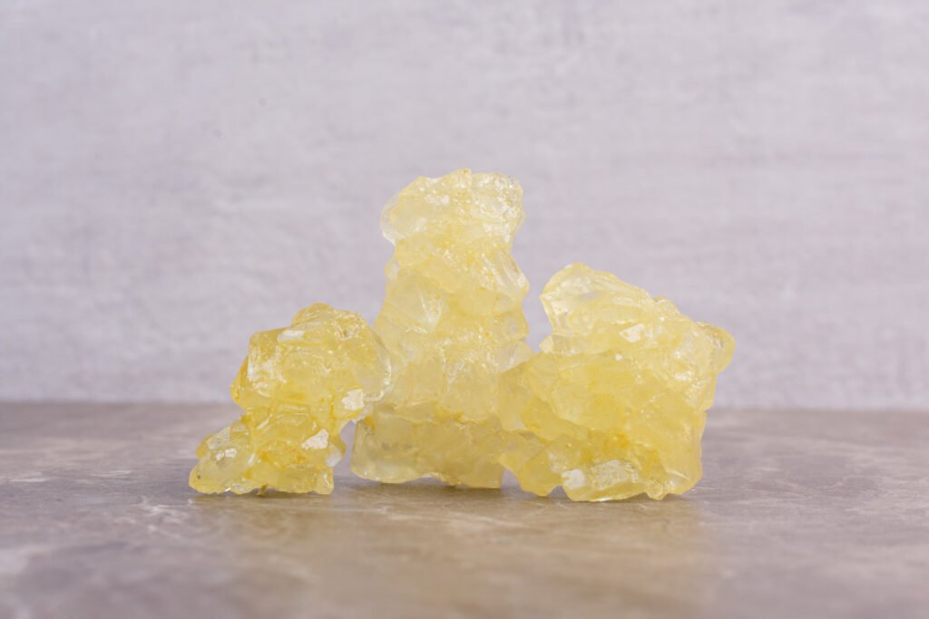 Yellow sugar candies on marble background . High quality photo